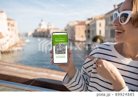 Woman with vaccination certificate while traveling in Italy 89924885