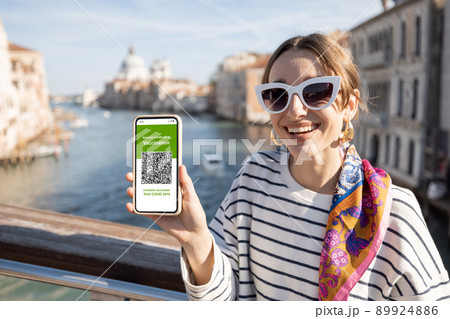 Woman with vaccination certificate while traveling in Italy 89924886