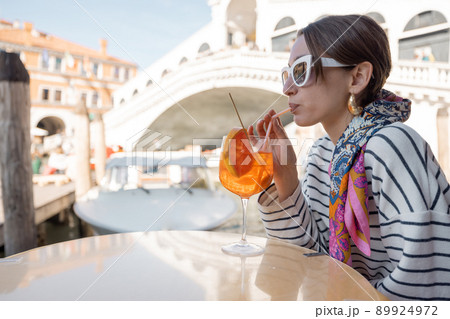 Woman rest at outdoor cafe on Grand Canal, traveling Venice Woman rest at outdoor cafe on Grand Canal, traveling Venice 89924972