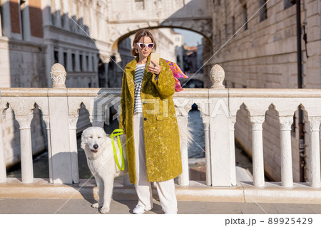 Woman walking central square while traveling in Venice Woman walking central square while traveling in Venice 89925429