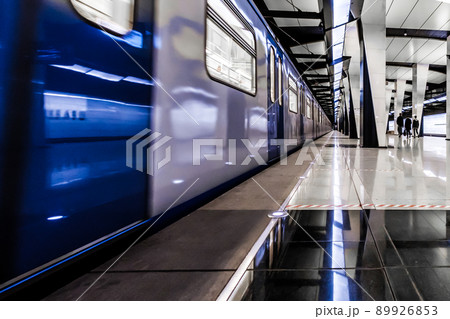 Modern metro station at night. A lonely girl is waiting for the train to arrive. 89926853