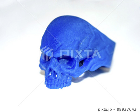 Model prototype human skull printed on 3d printer isolated on white background. Object photopolymer printed on stereolithography 3D printer. Technology of liquid photopolymerization under UV light. 89927642