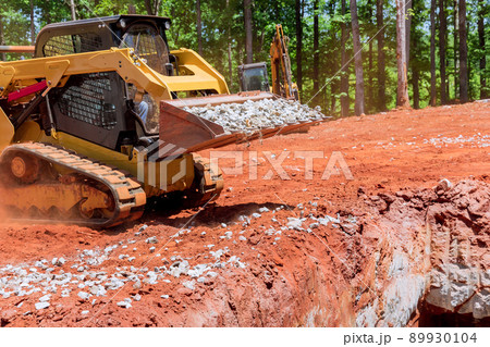 Industrial construction residential areas a small tractor of gravel moving Industrial construction residential areas a small tractor of gravel moving 89930104
