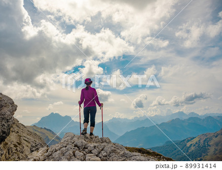 Sporty Young woman on mountain trail Dolomites Mountains, Italy Sporty Young woman on mountain trail Dolomites Mountains, Italy 89931414