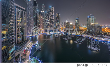 Dubai marina tallest skyscrapers and yachts in harbor aerial all night timelapse. Dubai marina tallest skyscrapers and yachts in harbor aerial all night timelapse. 89932725