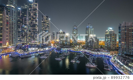 Luxury yacht bay in the city aerial night timelapse in Dubai marina 89932776