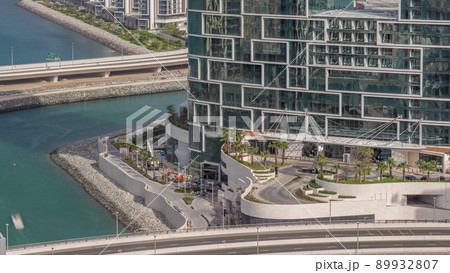 Promenade and Dubai cityscape seen from Dubai marina timelapse. Aerial view to JBR district and Bluewaters Island behind 89932807