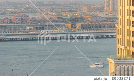 Aerial view of many luxury villas and hotels on the Palm Jumeirah island in Dubai timelapse. UAE 89932871