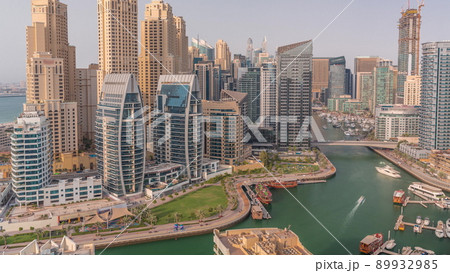 Dubai Marina with several boat and yachts parked in harbor and skyscrapers around canal aerial timelapse. Dubai Marina with several boat and yachts parked in harbor and skyscrapers around canal aerial timelapse. 89932985