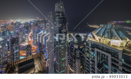 Panorama showing JBR district and Dubai Marina with JLT. Traffic between skyscrapers aerial night timelapse. 89933013