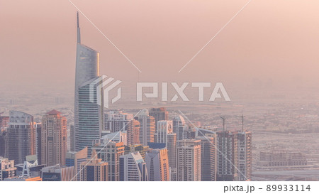 Jumeirah Lakes Towers district with many skyscrapers along Sheikh Zayed Road aerial timelapse. 89933114