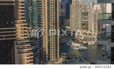Aerial view on Dubai Marina skyscrapers and the most luxury yacht in harbor timelapse, Dubai, United Arab Emirates 89933283