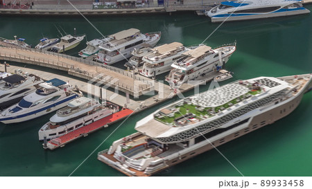 Aerial view to Dubai marina canal with floating boats timelapse 89933458