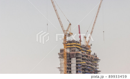 Skyscraper under construction with cranes and iron frame timelapse Skyscraper under construction with cranes and iron frame timelapse 89933459