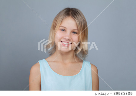 Happy smiling child girl portrait on gray background. Childhood lifestyle concept Happy smiling child girl portrait on gray background. Childhood lifestyle concept 89935309