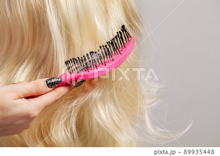 Hair care and hair loss concept. Long blonde hair and comb Hair care and hair loss concept. Long blonde hair and comb 89935448