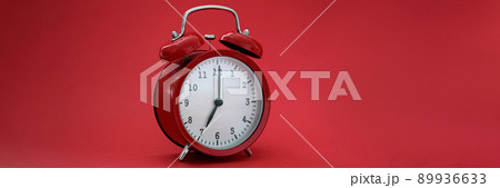 Red stylish alarm clock on a red background, close-up Red stylish alarm clock on a red background, close-up 89936633