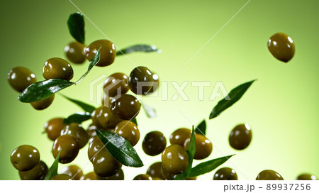 Freeze motion of flying green olives. Freeze motion of flying green olives. 89937256