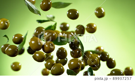 Freeze motion of flying green olives. 89937257