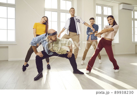 Group of young contemporary or hip hop dancers dancing together in a modern studio Group of young contemporary or hip hop dancers dancing together in a modern studio 89938230