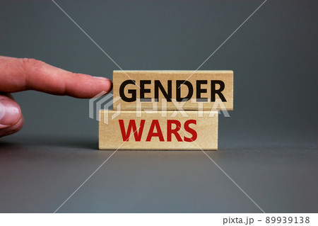 Gender wars symbol. Wooden blocks with words 'gender wars' on beautiful grey background. Male hand. Business and gender wars concept, copy space. 89939138