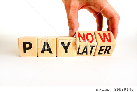 Pay later or now symbol. Businessman turns wooden cubes and changes concept words Pay later to Pay now. Beautiful white table white background. Business pay later or now concept. Copy space. Pay later or now symbol. Businessman turns wooden cubes and changes concept words Pay later to Pay now. Beautiful white table white background. Business pay later or now concept. Copy space. 89939146