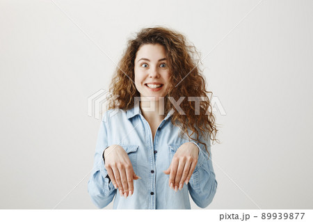 Funny girl showing bunny hands with her hands isolated on gray background 89939877