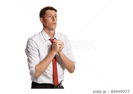 Portrait of a young brunet man posing in a studio isolated over a white background. 89940077