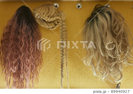 Wigs, natural and synthetic hair. Women's beauty concept. Close up photo of wig, hair for ladies. Wigs, natural and synthetic hair. Women's beauty concept. Close up photo of wig, hair for ladies. 89940927