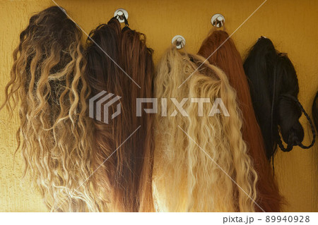 Wigs, natural and synthetic hair. Women's beauty concept. Close up photo of wig, hair for ladies. Wigs, natural and synthetic hair. Women's beauty concept. Close up photo of wig, hair for ladies. 89940928