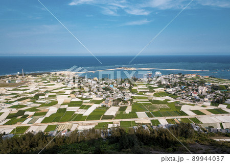 high view from Thoi Loi Mountain, fishing village and garlic fields at Ly Son island, Quang Ngai Province, Viet Nam 89944037