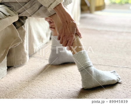 足のふくらはぎをストレッチする高齢女性の手 89945839