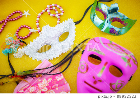 A festive,Beautiful white mardi gras or carnival mask on beautiful colorful paper background 89952522