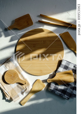 Empty wooden dishes, kitchen utensils on a white background. Eco-friendly tableware. Top view. Vertical photo 89953063