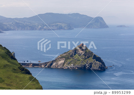 Hermitage on island Gaztelugatxe connected to emerald mainland cape cabo Matxitxako Hermitage on island Gaztelugatxe connected to emerald mainland cape cabo Matxitxako 89953299