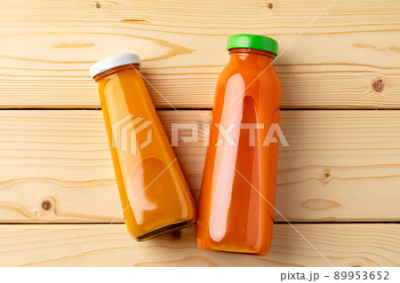 Juice bottles on wooden background flat lay Juice bottles on wooden background flat lay 89953652