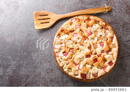 Sweet and sour delicious rhubarb pie with almonds close-up in a dish. horizontal top view 89955661