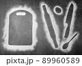 Baking dark background with the outlines of ingredient flour cutting board, rolling pin, spoon and knife flatlay with copy space. 89960589