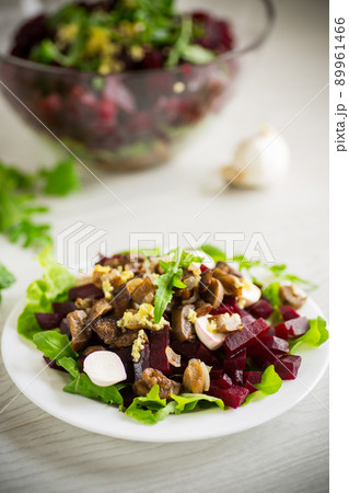Salad with boiled beets, fried eggplants, herbs and arugula in a plate Salad with boiled beets, fried eggplants, herbs and arugula in a plate 89961466