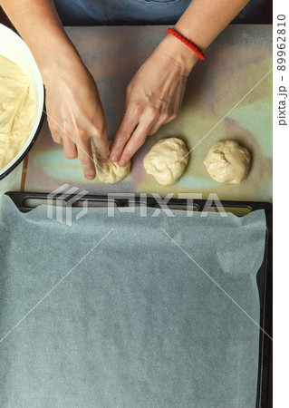 Confectioner forms buns with cherries from baking dough 89962810
