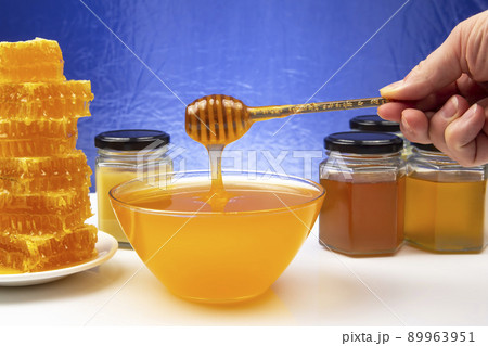 fresh floral honey dripping from a spoon into a plate. organic vitamin health food 89963951