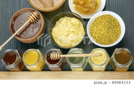 Hexagonal jars with different types and colors of fresh flower honey. 89964233