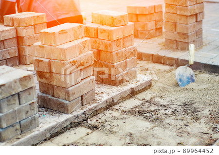 View of new paving slabs and concrete blocks on summer day at construction site. Stone blocks stand 89964452