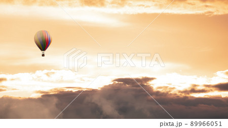 Hot Air Balloon flying over the Dramatic Cloudscape. 89966051