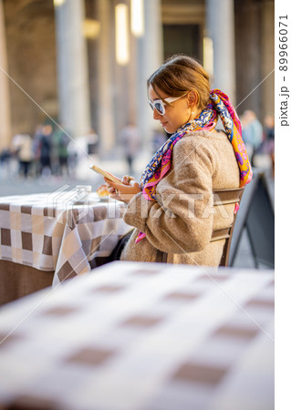 Woman sitting at outdoor cafe near Panthenon temple in Rome Woman sitting at outdoor cafe near Panthenon temple in Rome 89966071