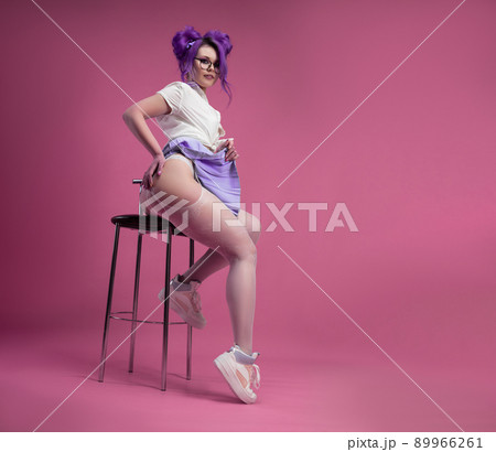 sexy schoolgirl girl with purple hair in summer short clothes and beautiful underwear on a pink background sexy schoolgirl girl with purple hair in summer short clothes and beautiful underwear on a pink background 89966261