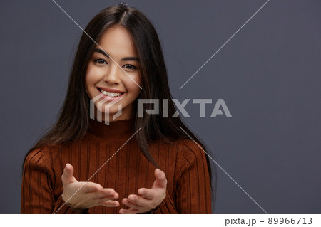 young woman hand gestures brown sweater fashion isolated background young woman hand gestures brown sweater fashion isolated background 89966713
