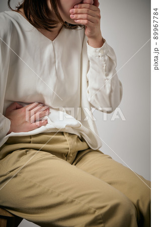 食中毒になり吐き気と腹痛がする若い女性 89967784