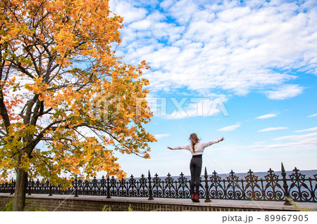 Beautiful autumn. Back side care free young adult wooman. Looking away and feeling freedom. Outdoor Beautiful autumn. Back side care free young adult wooman. Looking away and feeling freedom. Outdoor 89967905