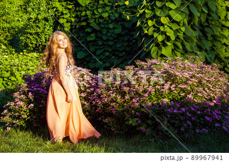 young girl standing and enjoying on summertime in the park young girl standing and enjoying on summertime in the park 89967941